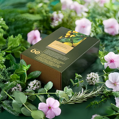 immagine del prodotto della sinergia detossinante ambientata su sfondo verde con fiori rosa